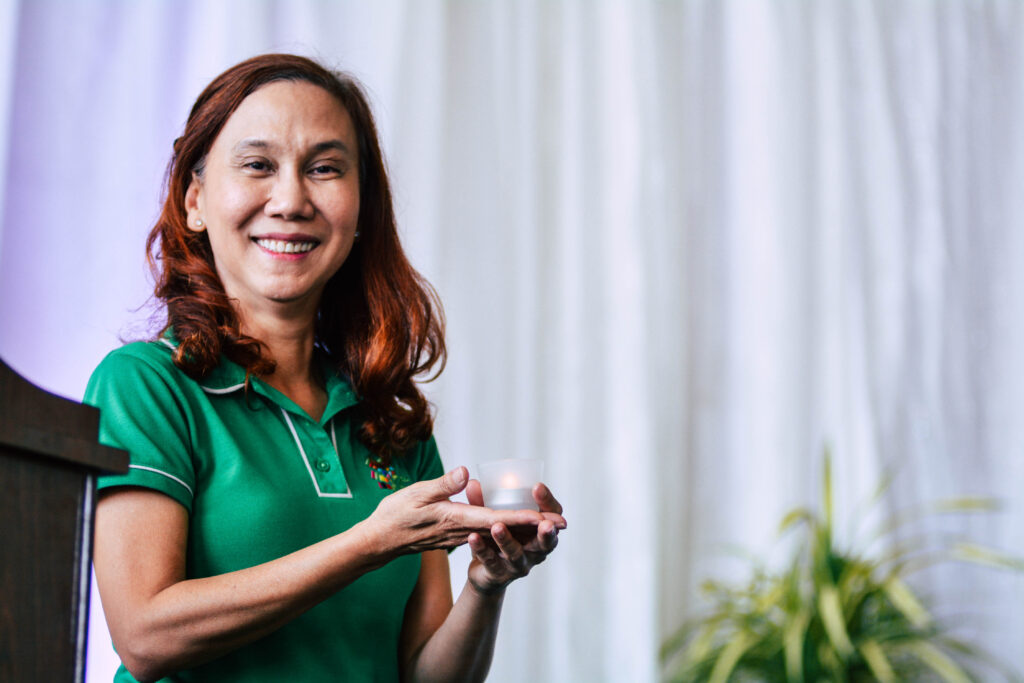 Teacher Ana speaking at a school event