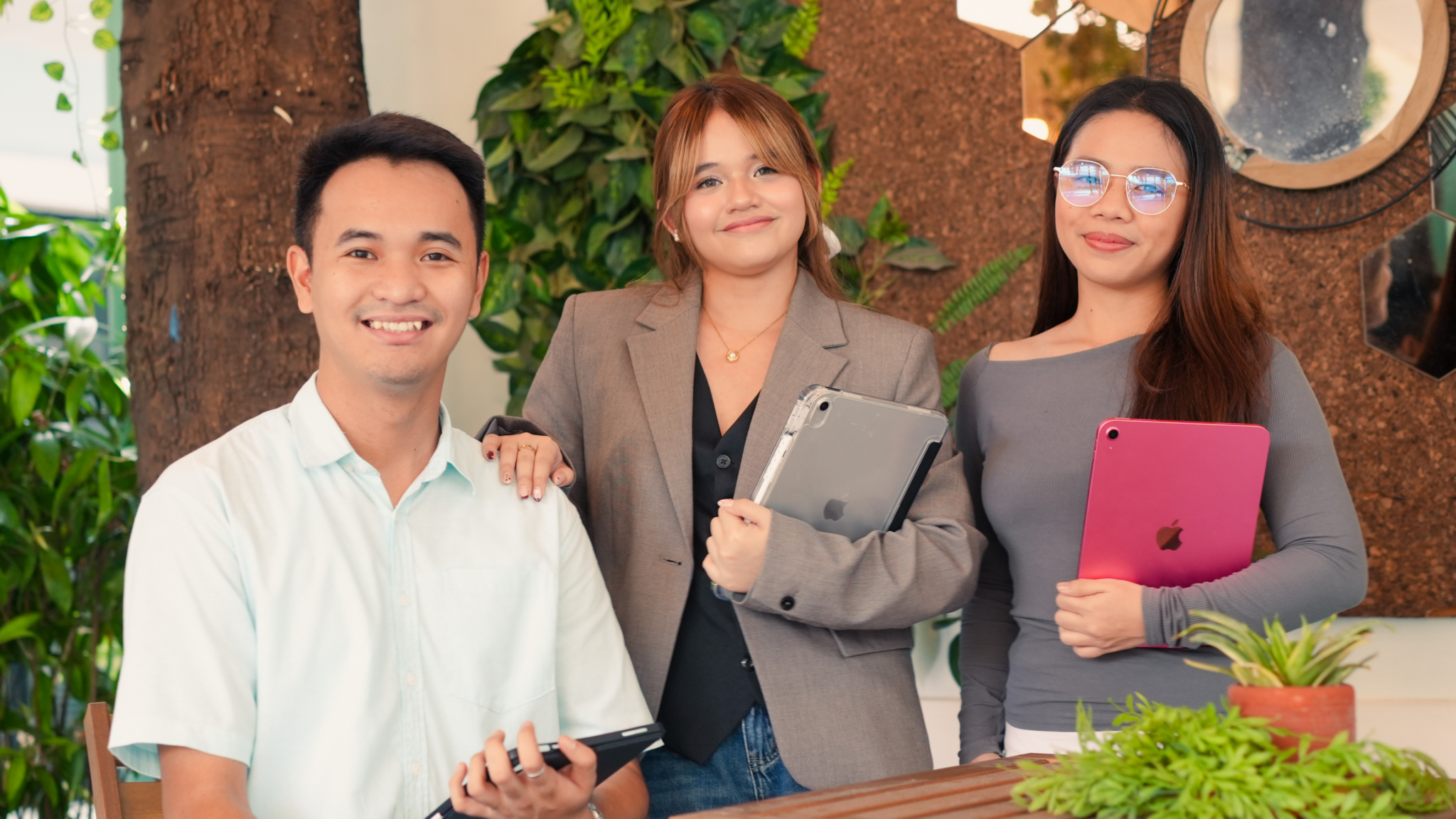 Three Brightwoods staff members holding iPads